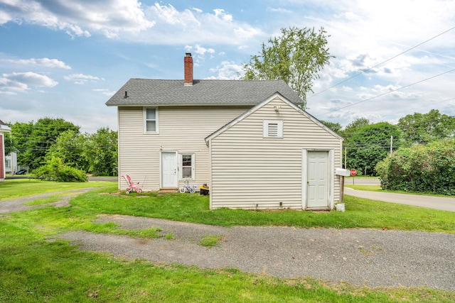 131 Pleasant St, Dexter, ME 04930 - view of side of property featuring a yard, a chimney, and roof with shingles