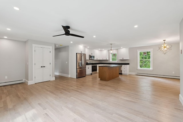 127 Bond Brook Rd, Augusta, ME 04330 - kitchen featuring stainless steel appliances, a baseboard heating unit, dark countertops, white cabinetry, and recessed lighting