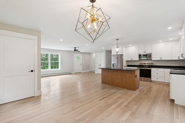 127 Bond Brook Rd, Augusta, ME 04330 - kitchen with appliances with stainless steel finishes, recessed lighting, a baseboard radiator, a kitchen island, and dark countertops