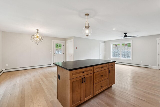 127 Bond Brook Rd, Augusta, ME 04330 - kitchen with a baseboard heating unit, dark countertops, light wood-style floors, and recessed lighting