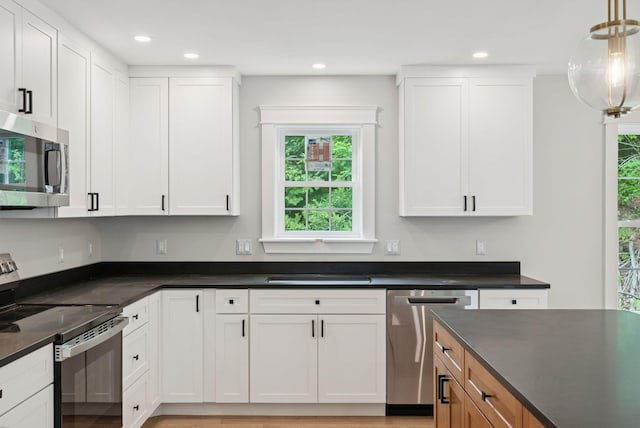 127 Bond Brook Rd, Augusta, ME 04330 - kitchen featuring stainless steel appliances, plenty of natural light, dark countertops, white cabinetry, and recessed lighting