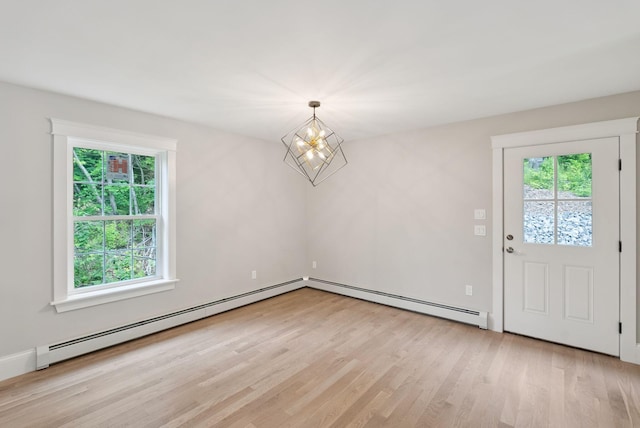 127 Bond Brook Rd, Augusta, ME 04330 - unfurnished dining area with a baseboard heating unit, light wood-style floors, and a chandelier