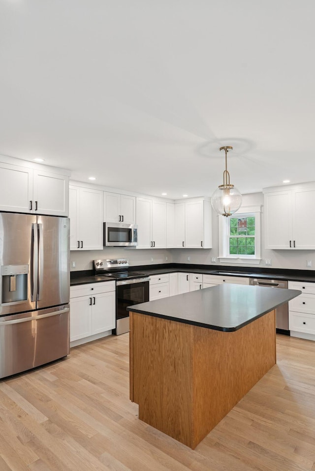 127 Bond Brook Rd, Augusta, ME 04330 - kitchen with appliances with stainless steel finishes, dark countertops, light wood finished floors, and recessed lighting