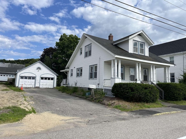 107 May St, Biddeford, ME 04005 - view of front facade featuring a detached garage, an outbuilding, a chimney, and covered porch