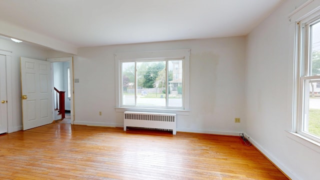 69 Androscoggin Ave, Lewiston, ME 04240 - spare room with radiator heating unit and light wood-style floors