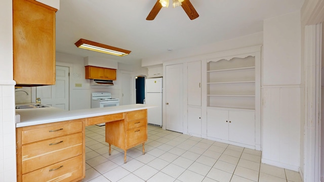 69 Androscoggin Ave, Lewiston, ME 04240 - kitchen with white appliances, ceiling fan, a peninsula, light countertops, and under cabinet range hood