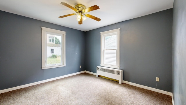 69 Androscoggin Ave, Lewiston, ME 04240 - empty room featuring radiator, plenty of natural light, carpet flooring, and ceiling fan