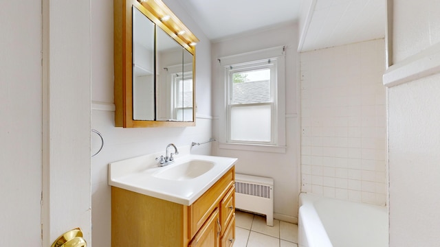 69 Androscoggin Ave, Lewiston, ME 04240 - full bathroom with radiator, vanity, a tub to relax in, and tile patterned floors