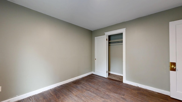 69 Androscoggin Ave, Lewiston, ME 04240 - unfurnished bedroom with dark wood finished floors and a closet