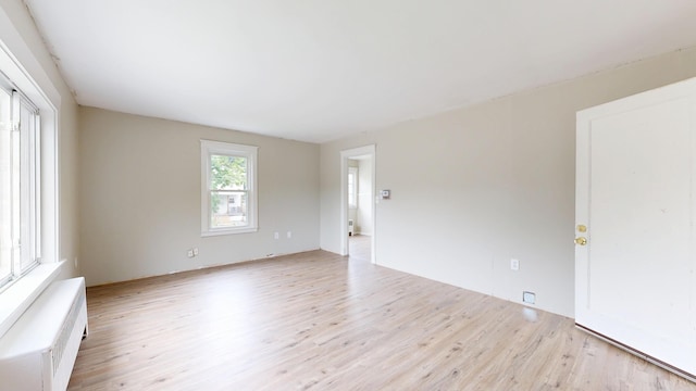 69 Androscoggin Ave, Lewiston, ME 04240 - unfurnished room featuring wood finished floors and radiator