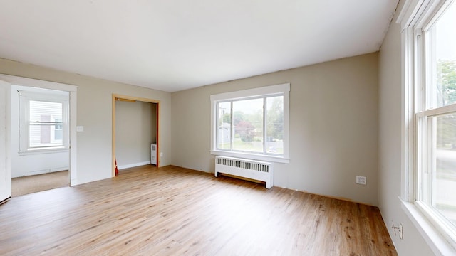 69 Androscoggin Ave, Lewiston, ME 04240 - unfurnished bedroom featuring radiator heating unit and wood finished floors