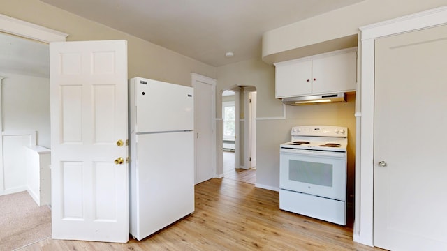 69 Androscoggin Ave, Lewiston, ME 04240 - kitchen with white appliances, under cabinet range hood, white cabinetry, light wood-type flooring, and arched walkways