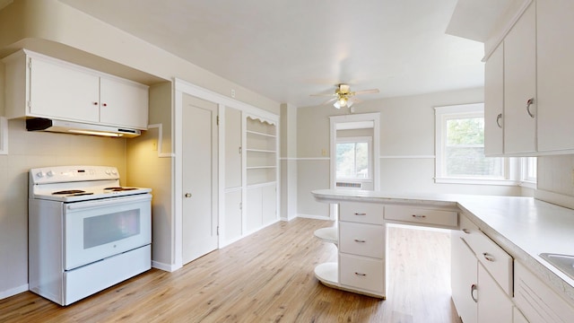 69 Androscoggin Ave, Lewiston, ME 04240 - kitchen featuring white range with electric stovetop, under cabinet range hood, white cabinets, light countertops, and light wood-type flooring