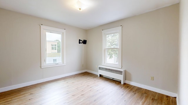 69 Androscoggin Ave, Lewiston, ME 04240 - unfurnished room with radiator heating unit and light wood-type flooring