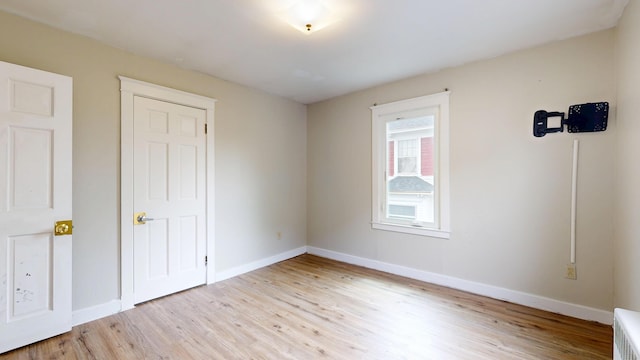 69 Androscoggin Ave, Lewiston, ME 04240 - unfurnished bedroom with light wood-style flooring and baseboards