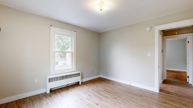 69 Androscoggin Ave, Lewiston, ME 04240 - unfurnished room with radiator, light wood finished floors, and a smoke detector