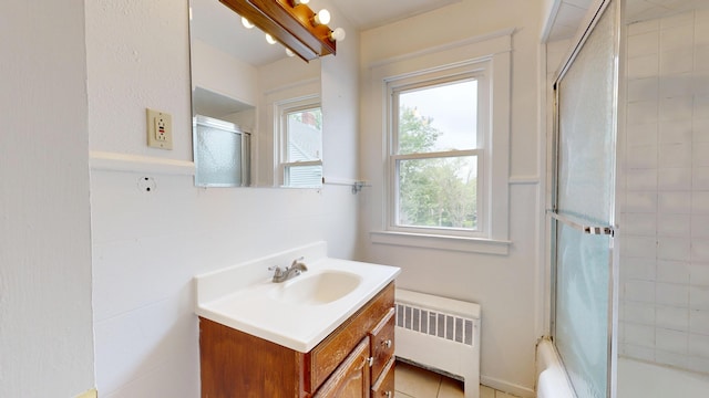 69 Androscoggin Ave, Lewiston, ME 04240 - full bath featuring radiator heating unit, vanity, and enclosed tub / shower combo