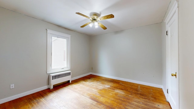 69 Androscoggin Ave, Lewiston, ME 04240 - empty room featuring radiator heating unit, light wood finished floors, and ceiling fan