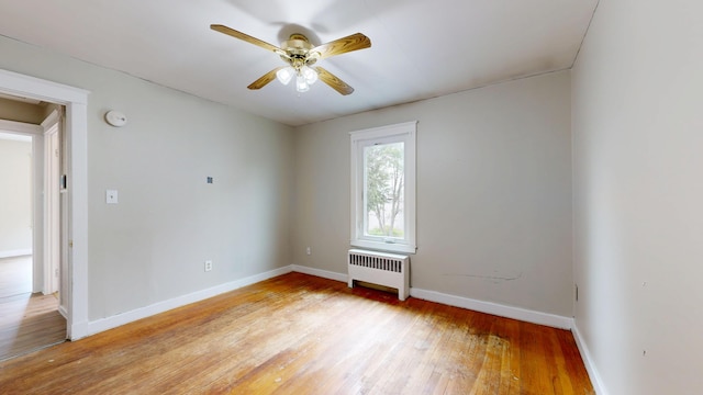 69 Androscoggin Ave, Lewiston, ME 04240 - unfurnished room featuring radiator, light wood-style flooring, ceiling fan, and a smoke detector