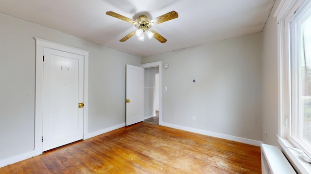 69 Androscoggin Ave, Lewiston, ME 04240 - unfurnished bedroom with light wood-type flooring, multiple windows, and ceiling fan