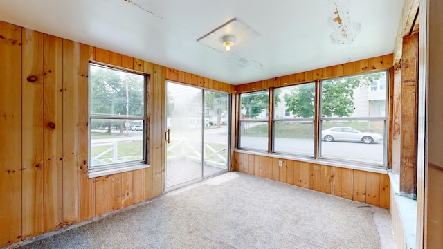 69 Androscoggin Ave, Lewiston, ME 04240 - unfurnished sunroom featuring carpet flooring and wood walls