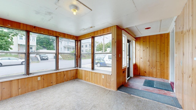 69 Androscoggin Ave, Lewiston, ME 04240 - unfurnished sunroom with carpet floors and wood walls