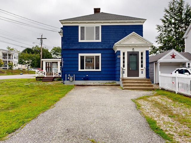 69 Androscoggin Ave, Lewiston, ME 04240 - view of front of property with an outbuilding, a chimney, and entry steps