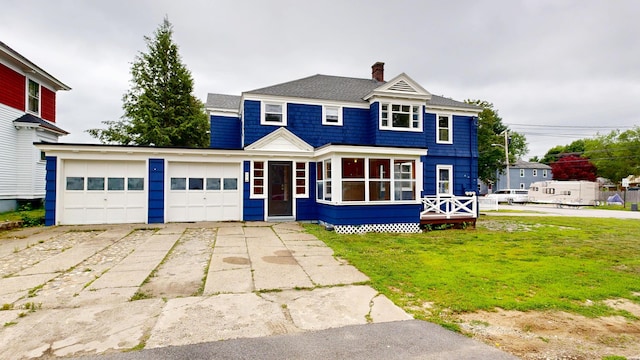 69 Androscoggin Ave, Lewiston, ME 04240 - view of front of property featuring a chimney, a garage, a front yard, and driveway