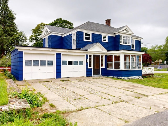 69 Androscoggin Ave, Lewiston, ME 04240 - shingle-style home featuring a chimney, a garage, a shingled roof, and driveway