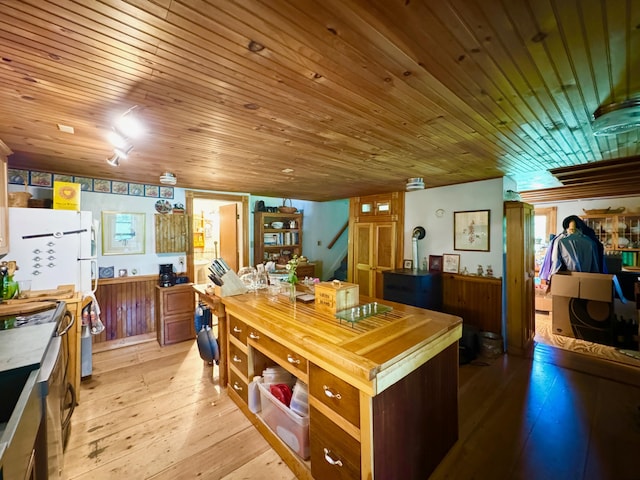 610 E Sangerville Rd, Sangerville, ME 04479 - kitchen with stove, light wood-style floors, and wooden ceiling
