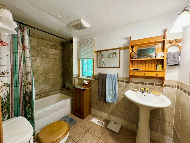 610 E Sangerville Rd, Sangerville, ME 04479 - full bath with tile walls, tile patterned flooring, shower / bathtub combination with curtain, and ornamental molding