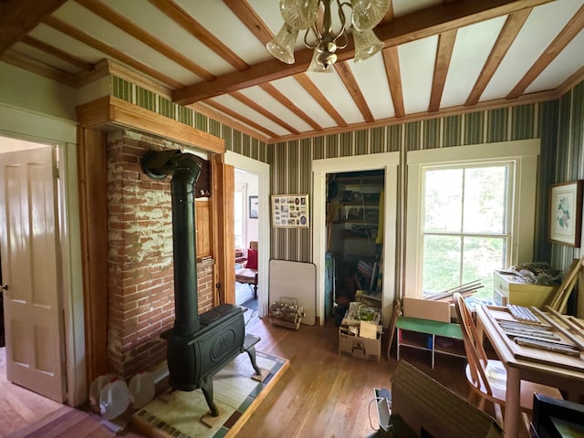 610 E Sangerville Rd, Sangerville, ME 04479 - office area with a wood stove, wood-type flooring, and a chandelier