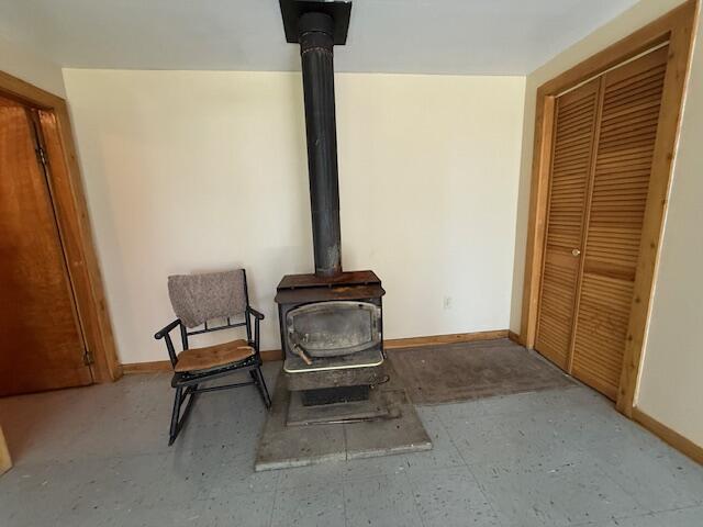 47 Tranquility Ln, Perry, ME 04667 - detailed view of a wood stove and baseboards