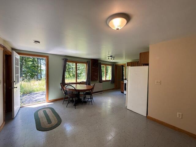 47 Tranquility Ln, Perry, ME 04667 - dining space featuring baseboards and light floors