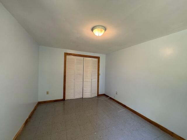 47 Tranquility Ln, Perry, ME 04667 - unfurnished bedroom with a closet and tile patterned floors
