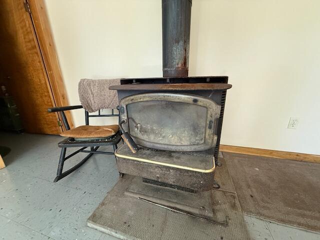 47 Tranquility Ln, Perry, ME 04667 - detailed view of a wood stove and baseboards