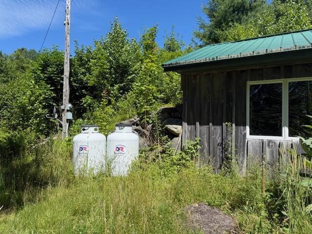 47 Tranquility Ln, Perry, ME 04667 - exterior view of gas tank and a metal roof