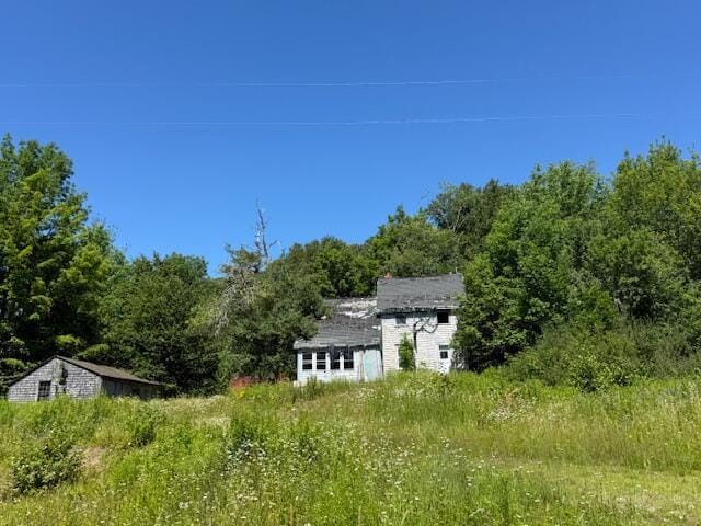 47 Tranquility Ln, Perry, ME 04667 - view of yard with an outbuilding and a forest view