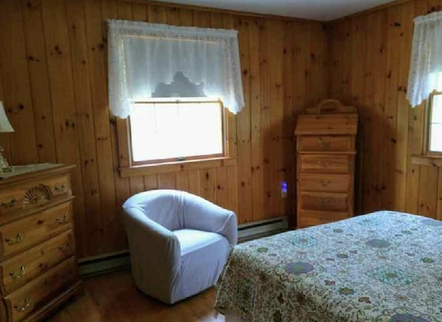 124 Main Rd, Westport Island, ME 04578 - bedroom with baseboard heating, multiple windows, wood walls, and wood finished floors