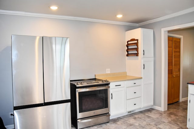 26 Elm St, Old Town, ME 04468 - kitchen with appliances with stainless steel finishes, white cabinets, ornamental molding, light countertops, and recessed lighting