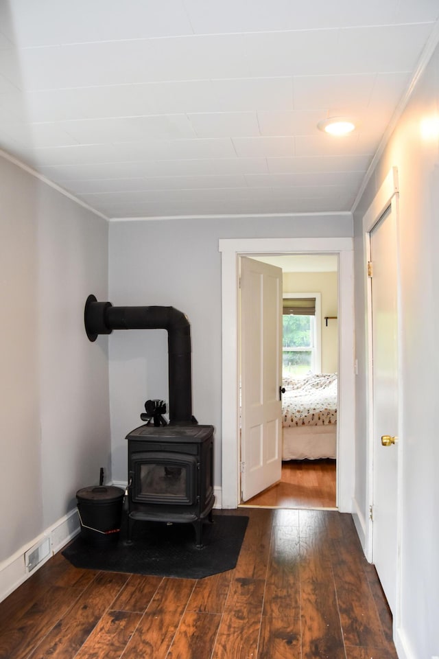 26 Elm St, Old Town, ME 04468 - living room featuring hardwood / wood-style floors, crown molding, and a wood stove