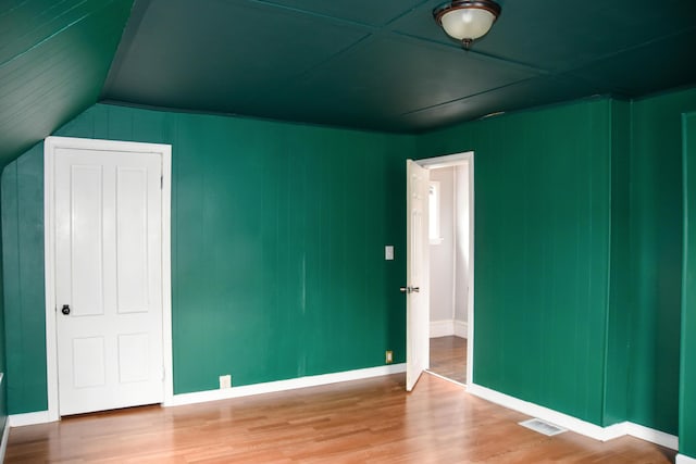 26 Elm St, Old Town, ME 04468 - unfurnished bedroom with wood finished floors and lofted ceiling