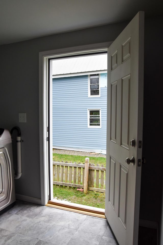 26 Elm St, Old Town, ME 04468 - entryway featuring washer / dryer and stone finish flooring