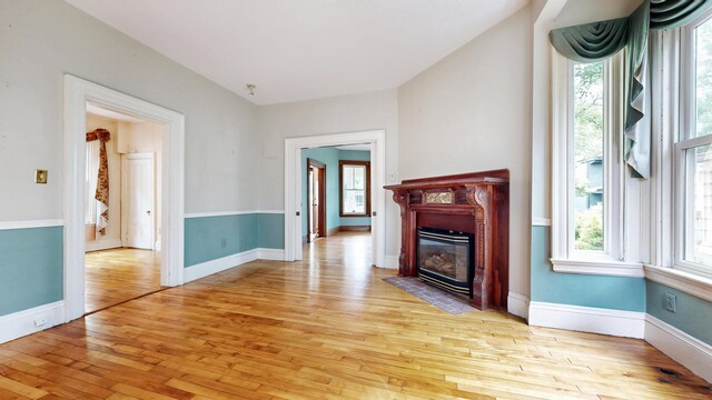 93 Fessenden St, Portland, ME 04103 - unfurnished living room featuring light wood-style flooring and a fireplace with flush hearth