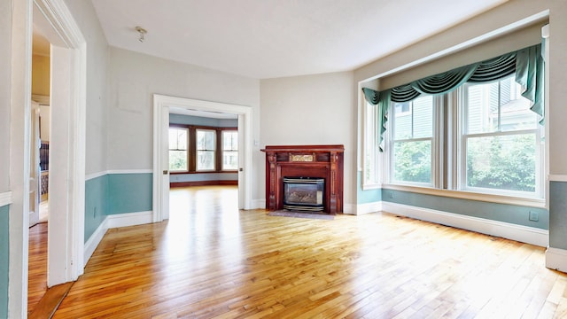 93 Fessenden St, Portland, ME 04103 - unfurnished living room with light wood-style floors and a fireplace with flush hearth