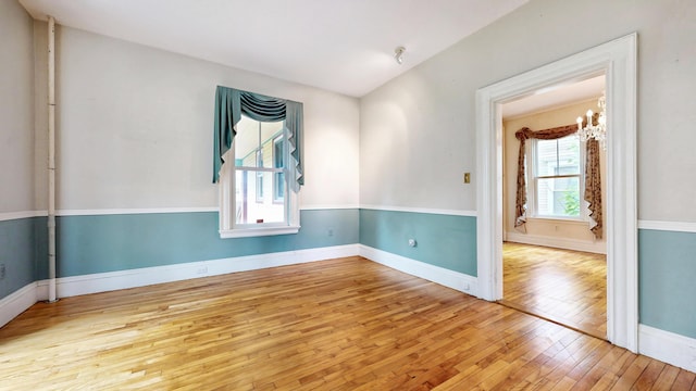93 Fessenden St, Portland, ME 04103 - spare room featuring hardwood / wood-style flooring and a chandelier