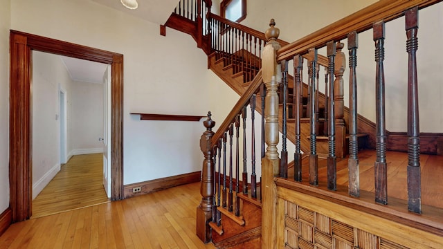 93 Fessenden St, Portland, ME 04103 - stairs featuring hardwood / wood-style floors and crown molding