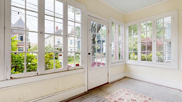 93 Fessenden St, Portland, ME 04103 - unfurnished sunroom featuring hardwood / wood-style floors, ornamental molding, healthy amount of natural light, and french doors