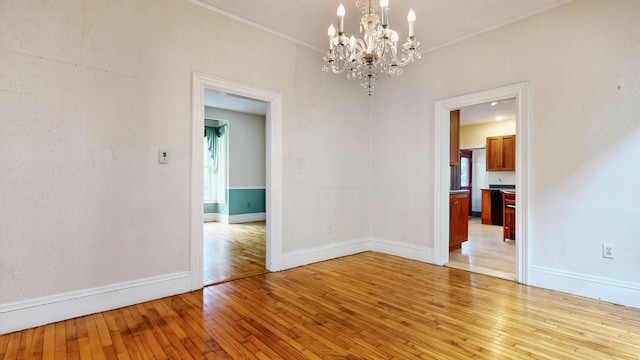 93 Fessenden St, Portland, ME 04103 - empty room with a chandelier, light wood-style flooring, and crown molding