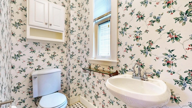 93 Fessenden St, Portland, ME 04103 - half bath with a sink and wallpapered walls